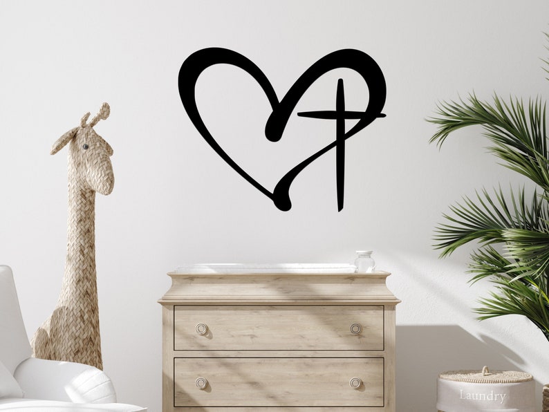 A casual-shaped heart outline and cross are connected together to hang on the wall as a single piece.