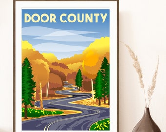 May include: A vintage-style poster with the text "DOOR COUNTY" in yellow letters on a blue background. The poster depicts a winding road through a forest with fall foliage in shades of orange, yellow, and green.