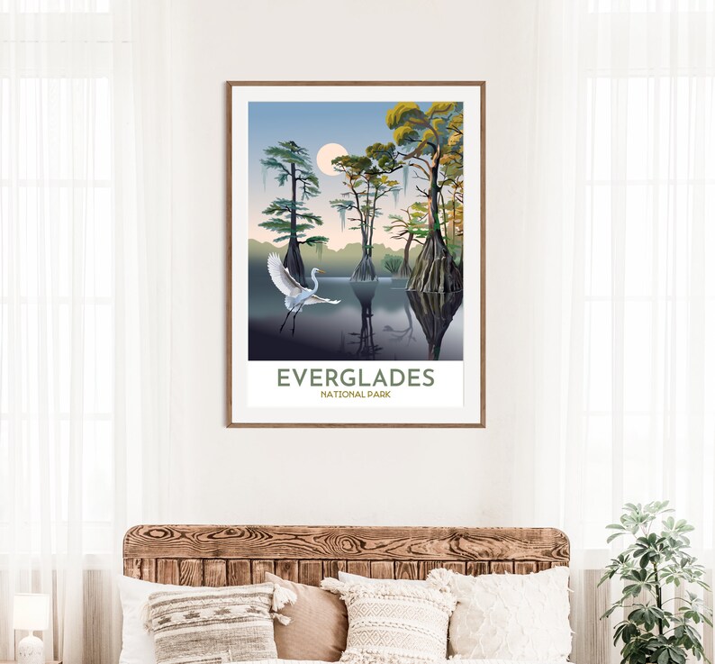 May include: A poster with a stylized illustration of a white egret flying over a swamp with cypress trees. The text "Everglades National Park" is at the bottom of the poster.