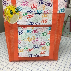 Bright orange vinyl mesh bag with colorful fish cotton fabric and puffer fish appliqué.
