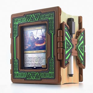 May include: A 3D printed book-shaped case with a green and brown design. The case has a slot for a Magic: The Gathering card, which is visible in the image. The card is "me, Master Chef", a legendary creature card with the text "Trample. At the beginning of your end step, create a number of Food tokens equal to the number of nontoken creatures you had enter the battlefield under your control this turn. 1. Sacrifice a Food: Target creature gains indestructible until end of turn. Tap it. 5/3".