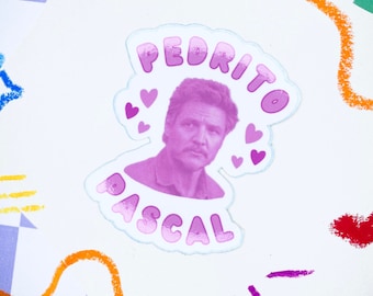 May include: A pink and white sticker with the text "PEDRITO PASCAL" in a bubble font. The sticker features a photo of Pedro Pascal with hearts around his head.