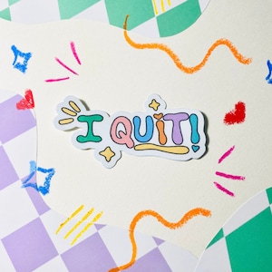 May include: A colorful sticker with the text "I QUIT!" on a white background with colorful scribbles.