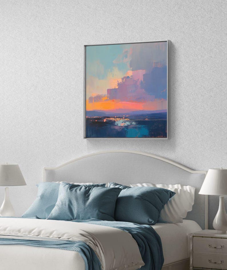 May include: A framed abstract painting depicting a sunset over a body of water. The painting features a vibrant pink and orange sky with blue and green water in the foreground.