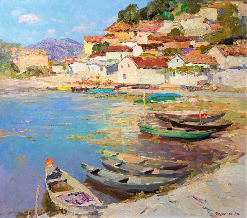 May include: A painting of a small village on a waterfront with several boats docked. The village is built on a hillside with white buildings and red tile roofs. The water is a light blue color and the sky is a clear blue.