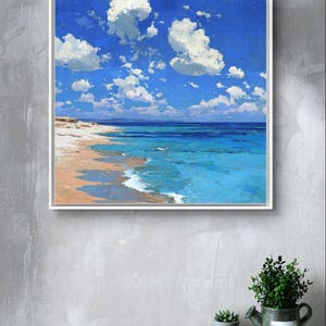 May include: A framed painting of a beach scene. The artwork depicts a bright blue sky filled with fluffy white clouds. The ocean transitions from turquoise to deep blue, meeting a sandy beach.