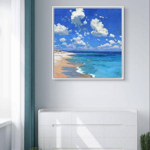 May include: A framed painting of a beach scene. The artwork depicts a bright blue sky filled with fluffy white clouds. The ocean transitions from turquoise to deep blue, meeting a sandy shore.