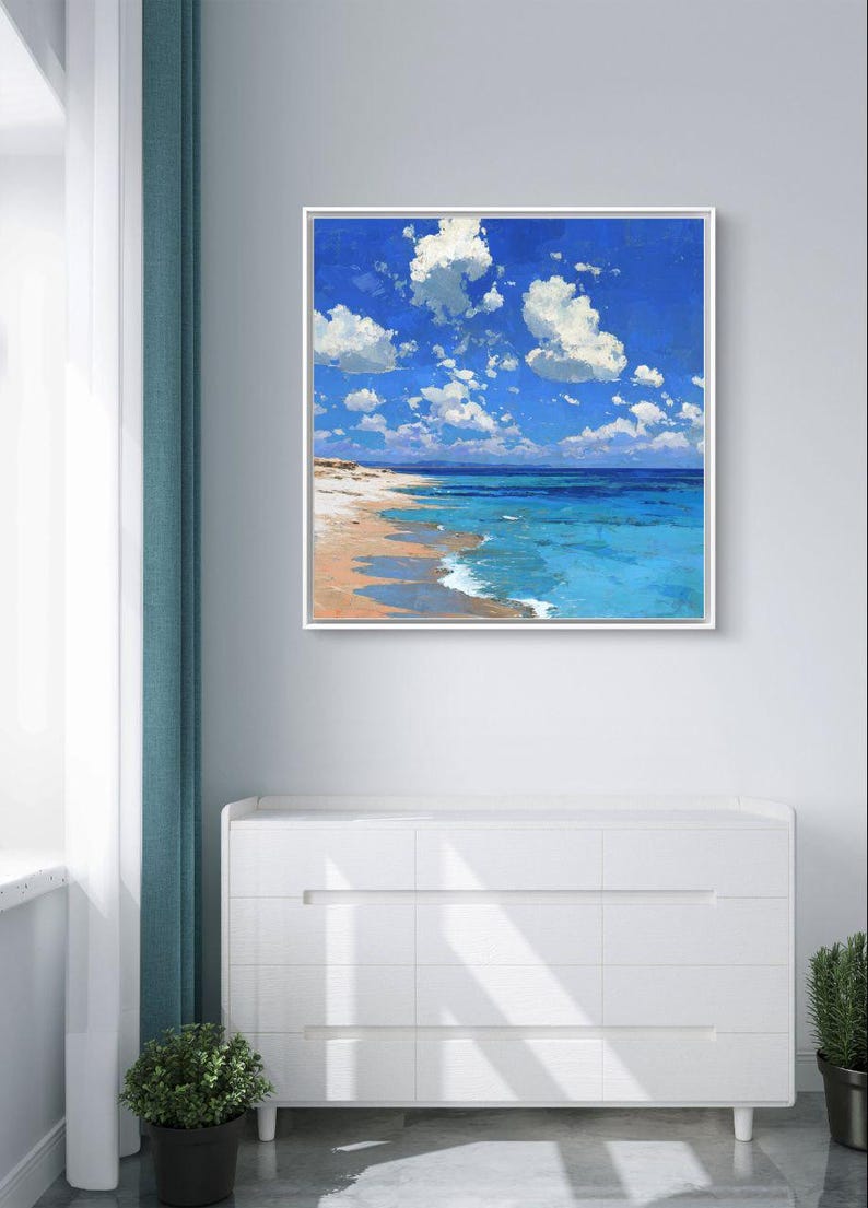 May include: A framed painting of a beach scene. The artwork depicts a bright blue sky filled with fluffy white clouds. The ocean transitions from turquoise to deep blue, meeting a sandy shore.