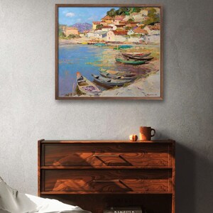 May include: A painting of a small village on a waterfront with several boats docked. The village is built on a hillside with red tile roofs and white walls. The water is a light blue with green algae. The sky is a light blue with white clouds.