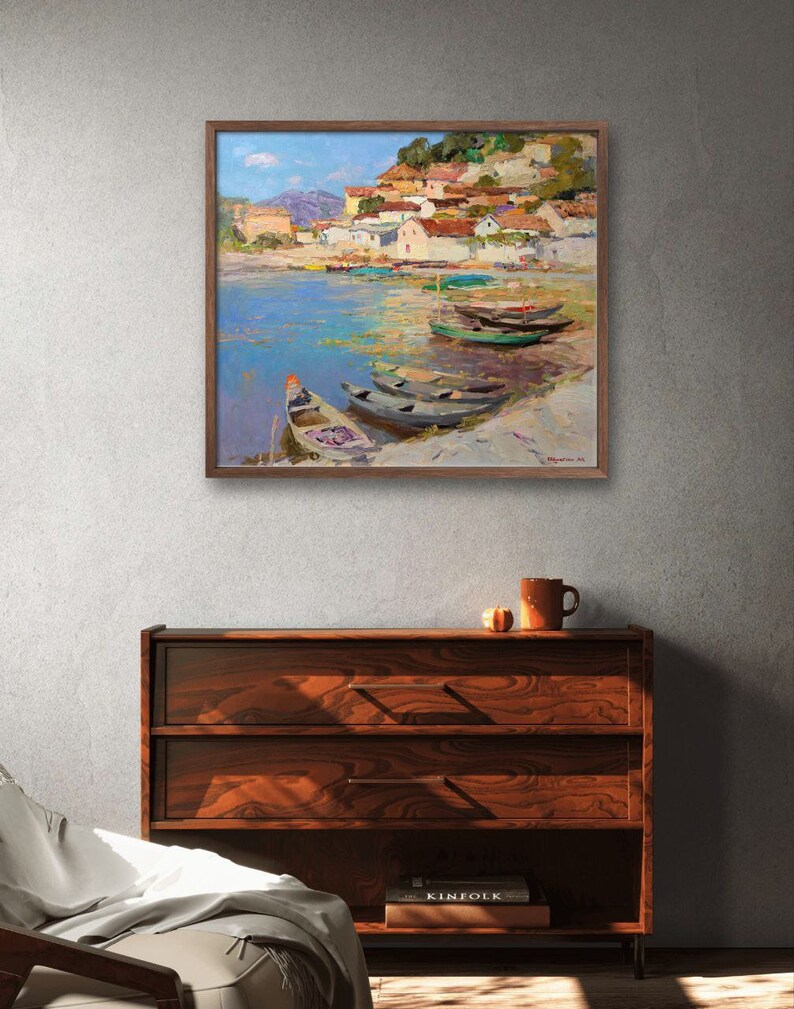 May include: A painting of a small village on a waterfront with several boats docked. The village is built on a hillside with red tile roofs and white walls. The water is a light blue with green algae. The sky is a light blue with white clouds.