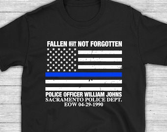 May include: Black t-shirt with a thin blue line American flag and the text "Fallen But Not Forgotten"  "Police Officer William Johns Sacramento Police Dept. EOW 04-29-1990"