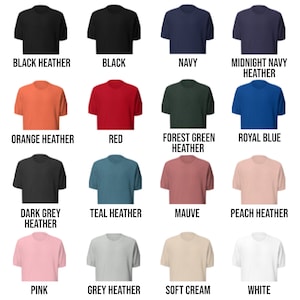 May include: A selection of t-shirts in various colors, including black, navy, red, orange, teal, mauve, peach, pink, grey, and white. The shirts are all short-sleeved and have a crew neck.