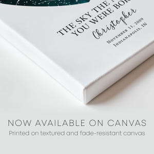 a white book with a green leaf on it