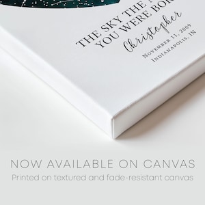 a white book with a green leaf on it