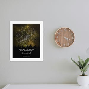 a clock mounted to a wall next to a plant