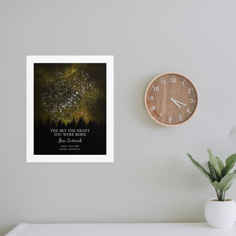 a clock mounted to a wall next to a plant