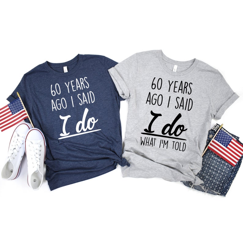 May include: Two t-shirts with a 60th anniversary theme. The blue shirt says "60 years ago I said I do". The gray shirt says "60 years ago I said I do what I'm told".