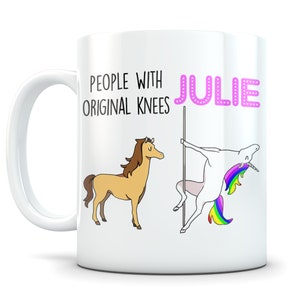 May include: White ceramic mug with the name "Julie" in pink bubble letters. The mug features a cartoon illustration of a horse and a unicorn pole dancing. Text reads "People with Original Knees".