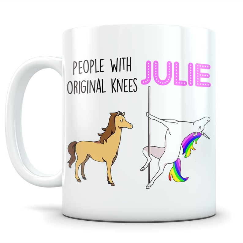 May include: White ceramic mug with the name "Julie" in pink bubble letters. The mug features a cartoon illustration of a horse and a unicorn pole dancing. Text reads "People with Original Knees".