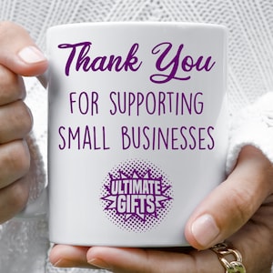 May include: White ceramic mug with purple text that reads "Thank You for Supporting Small Businesses" and a purple starburst with the text "Ultimate Gifts" in the center.