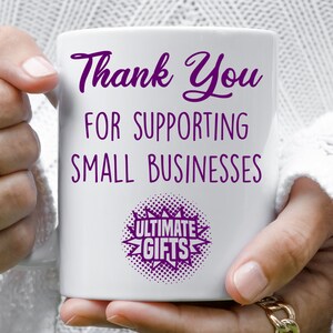 May include: White ceramic mug with purple text that reads "Thank You for Supporting Small Businesses" and a purple starburst with the text "Ultimate Gifts".