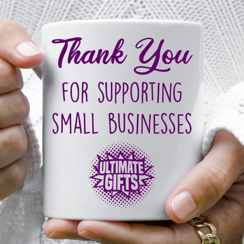 May include: White ceramic mug with purple text that reads "Thank You for Supporting Small Businesses" and a purple starburst with the text "Ultimate Gifts".