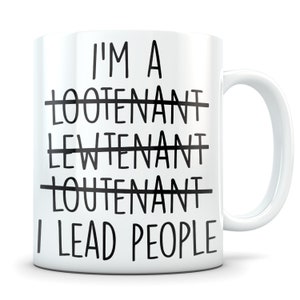 May include: White ceramic coffee mug with black text that reads "I'm a Loote-nant Lewtenant Loutenant I Lead People" with the first three words crossed out.