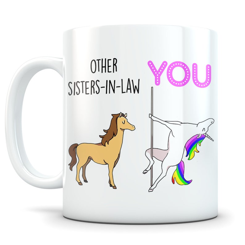 May include: White ceramic mug with a humorous saying about sisters-in-law. The text reads "Other Sisters-in-Law You". The mug features a cartoon horse and a unicorn.