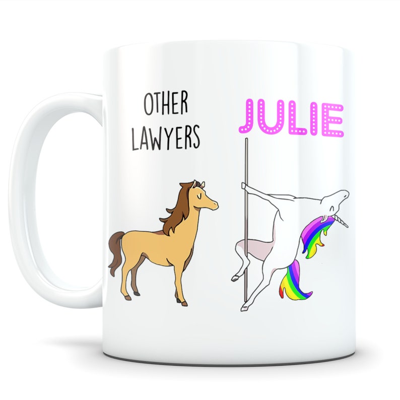 May include: White ceramic mug with a brown horse and a unicorn with a rainbow mane and tail. The text "OTHER LAWYERS" is above the horse and the text "JULIE" is above the unicorn.