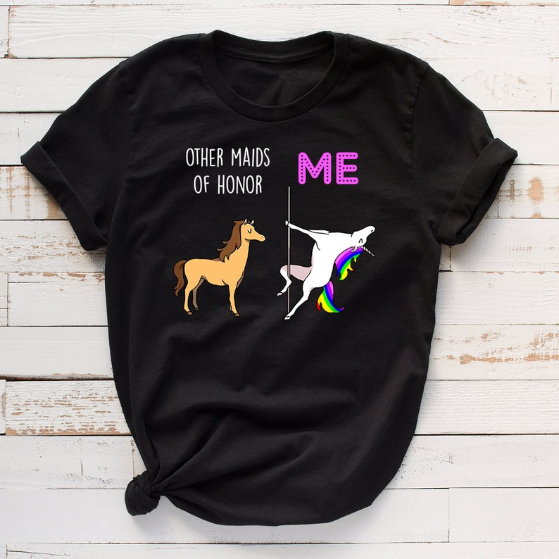 May include: Black t-shirt with a white graphic of a horse and a unicorn. The text "Other Maids of Honour" is above the horse and "ME" is above the unicorn.