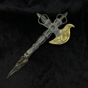 May include: An ornate, antique-style ceremonial axe with a detailed design. The axe features a cross-shaped top, a decorative handle, and a curved blade with gold-colored accents. The overall color scheme is a mix of bronze and gold.
