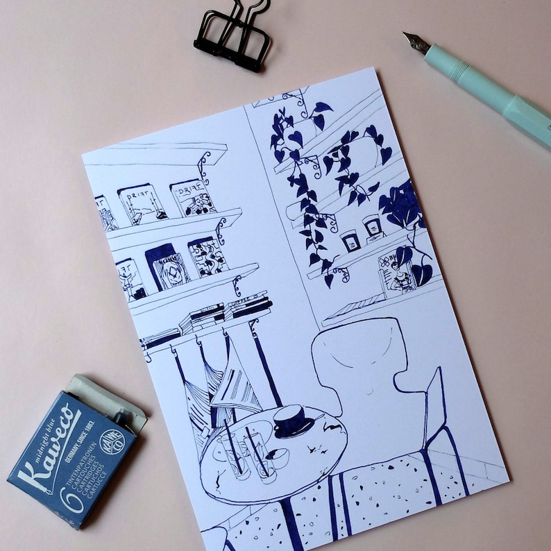 May include: A black and white ink drawing of a bookshelf with books, a table with a chair, and a plant hanging from the ceiling. The drawing is on a white background.