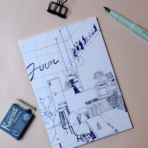 May include: A blue and white line drawing of a cafe interior with the word "Joon" written in large letters. The drawing includes tables, chairs, and a bar with bottles on shelves.