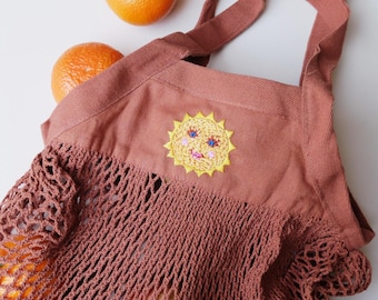Hand-embroidered crochet bag with sun motif