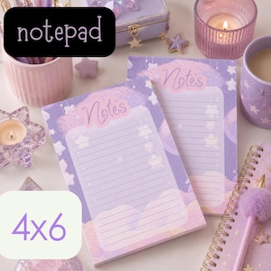 May include: Two 4x6 inch notepads with a pastel purple and pink design featuring clouds and stars. The word "Notes" is written at the top of the lined pages. The word "notepad" is in a black rectangle.