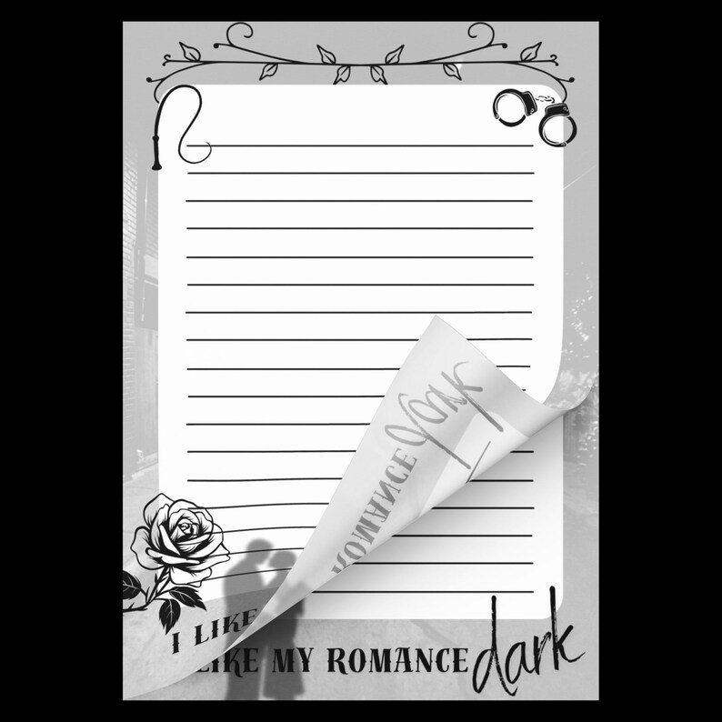 May include: A rectangular notepad with horizontal lines, featuring a black and white design with a rose, handcuffs, and a whip. The bottom corner is folded up, revealing the text "I LIKE MY ROMANCE dark" printed in a mix of serif and script fonts.