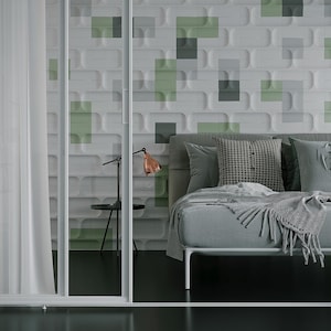 May include: A modern bedroom with a gray bed, pillows, and a blanket. The wall behind the bed has a geometric pattern with green and gray squares. A small black side table with a copper lamp is next to the bed. Sheer white curtains are on the left.