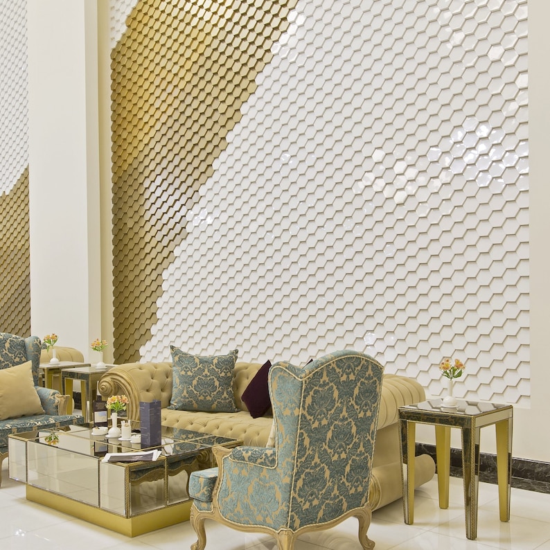 An office featuring a wall covered in white and gold NORM hexagonal 3D wall panels, creating a modern, minimalist honeycomb pattern.