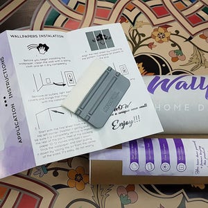 May include: Instructions for applying wallpaper with a squeegee tool. The instructions include cleaning the wall, aligning the wallpaper, and using the squeegee to smooth out air bubbles. The text reads "Wallpaper Home Design Decor" and "Enjoy!!!".