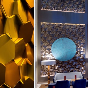 A spacious living room featuring a feature wall covered in white NORM hexagonal 3D wall panels, creating a modern, minimalist honeycomb pattern.