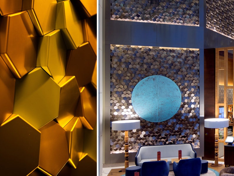 A spacious living room featuring a feature wall covered in white NORM hexagonal 3D wall panels, creating a modern, minimalist honeycomb pattern.