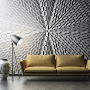 A creative studio, illuminated by lights that cast dynamic, colorful shadows across the 3D Mabel geometric wall panels.