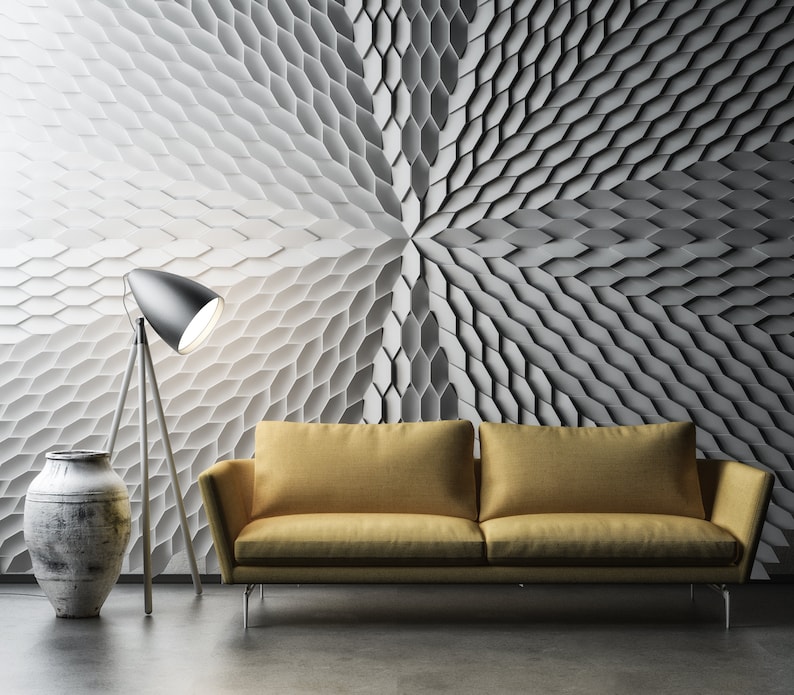 A creative studio, illuminated by lights that cast dynamic, colorful shadows across the 3D Mabel geometric wall panels.