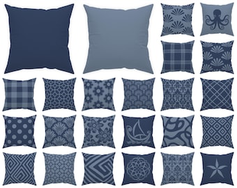 May include: A selection of 20 square cushions in shades of blue. Each cushion displays a different pattern, including solid colours, floral designs, geometric shapes, and nautical themes. The text at the top says "Swipe to see all 70 pillows!" and the text at the bottom says "Each pillow is numbered for easy selection."