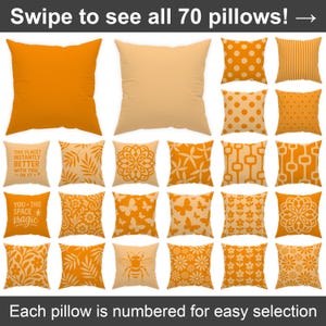 May include: A collection of 70 orange and cream throw pillows with various patterns, including geometric, floral, and abstract designs. The text "Swipe to see all 70 pillows!" is at the top of the image. The text "This place? Instantly better with you - in it." and "You + this space = magic" are on two of the pillows. The text "Each pillow is numbered for easy selection" is at the bottom of the image.