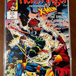 May include: A comic book cover featuring a red-haired woman in a green and black suit kicking a blue-clad man. The cover is titled "Hell's Angel" and features the text "Co-starring X-Men" and "Inside: The Origin of Hell's Angel is Told!"