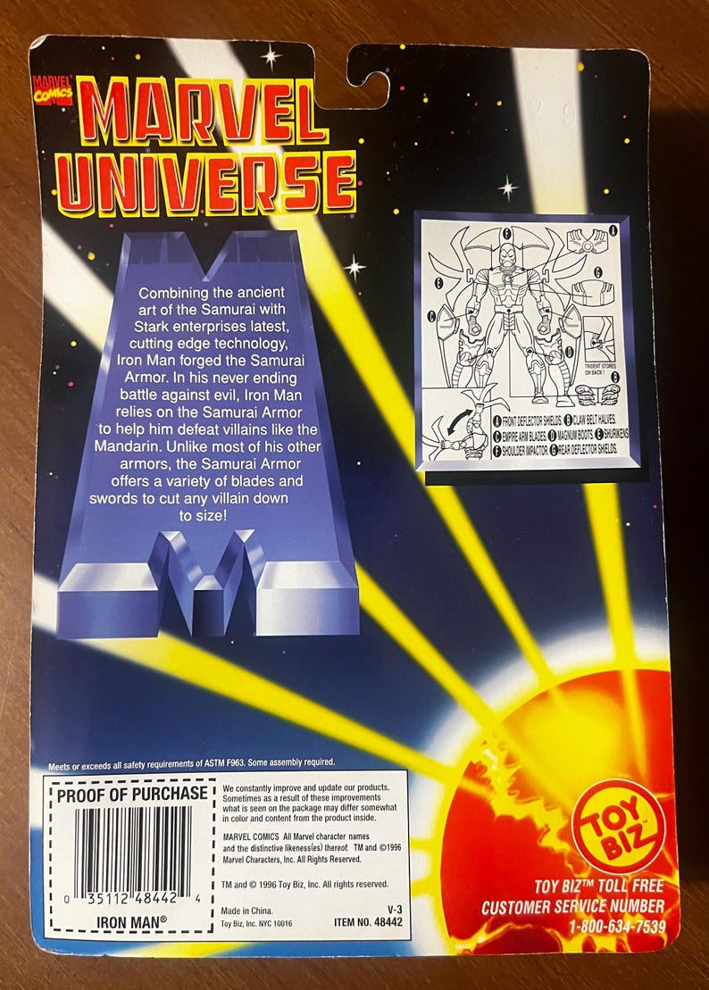 May include: A red, white, and blue action figure of Iron Man in his Samurai Armor. The figure is posed with its arms outstretched and has a red and gold helmet. The packaging features a yellow and orange background with the words "Marvel Universe" in large, bold letters. The back of the packaging shows a diagram of the figure's armor and its various parts.