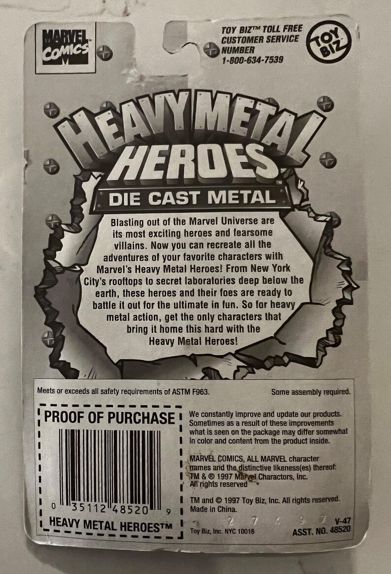 Pode incluir: Uma embalagem cinza e branca de figuras de a&ccedil;&atilde;o de metal fundido Heavy Metal Heroes. A embalagem apresenta o logotipo da Marvel Comics e o texto "Heavy Metal Heroes". A parte de tr&aacute;s da embalagem tem uma descri&ccedil;&atilde;o do produto.