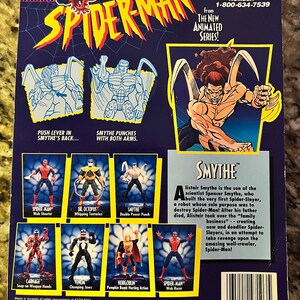 May include: A plastic action figure of Spider-Man's nemesis, Smythe, from the animated series. The figure is red and black with a yellow spider symbol on the chest. The figure is posed in a fighting stance with its arms outstretched. The figure is packaged on a blue and white card with a picture of Smythe on the back. The card also includes a description of Smythe's character and a list of other Spider-Man action figures.