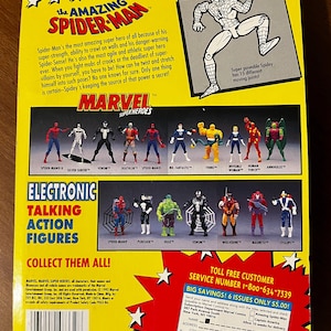 May include: The back of a cardboard box featuring the Marvel Super Heroes range of action figures. The box is red, yellow and blue with a picture of Spider-Man on the front. The back of the box shows a variety of action figures, including Spider-Man, Venom, Hulk, Wolverine and Magneto. The box also includes a toll-free customer service number and a subscription offer for Marvel Comics.